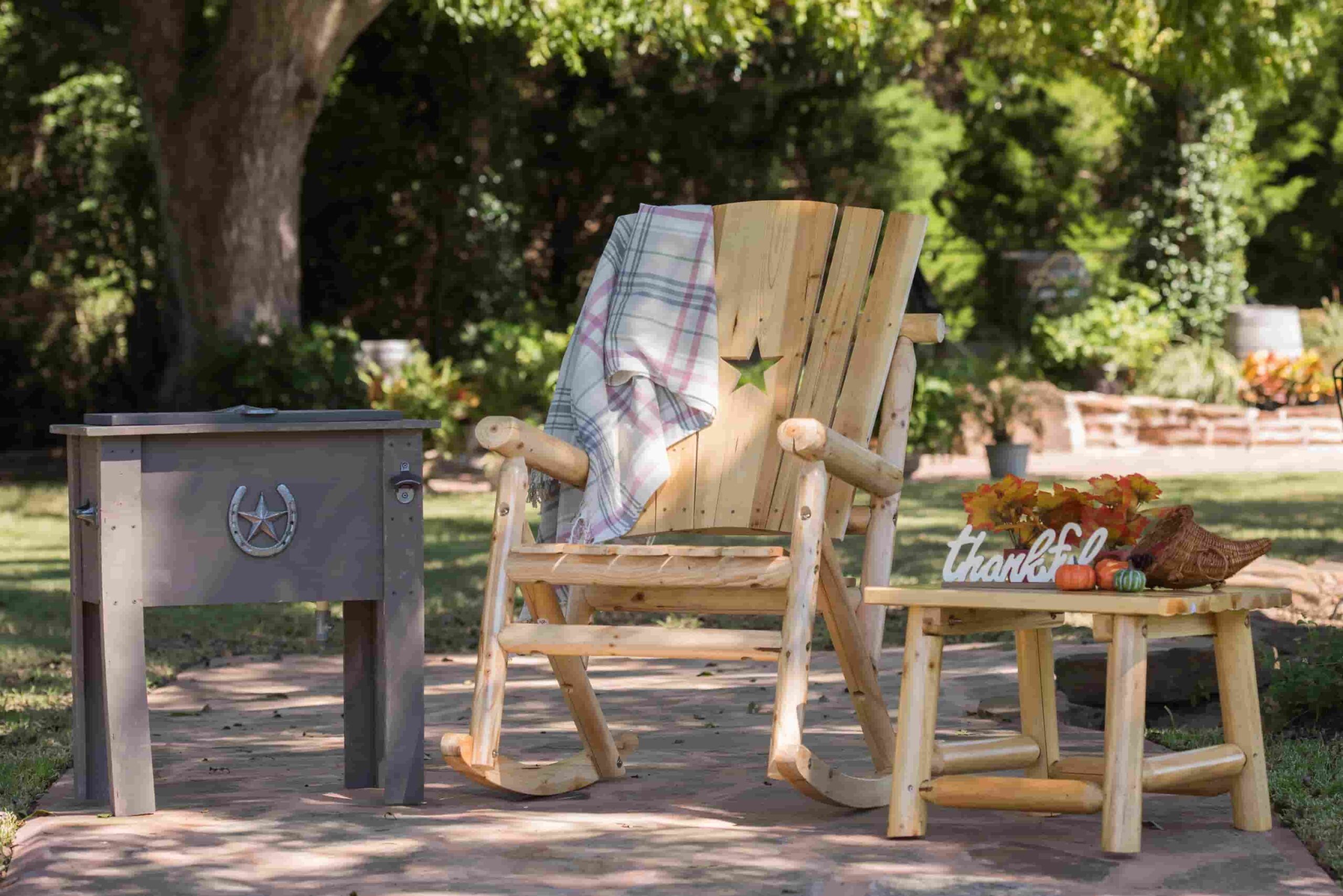 A rocking chair under a tree.
